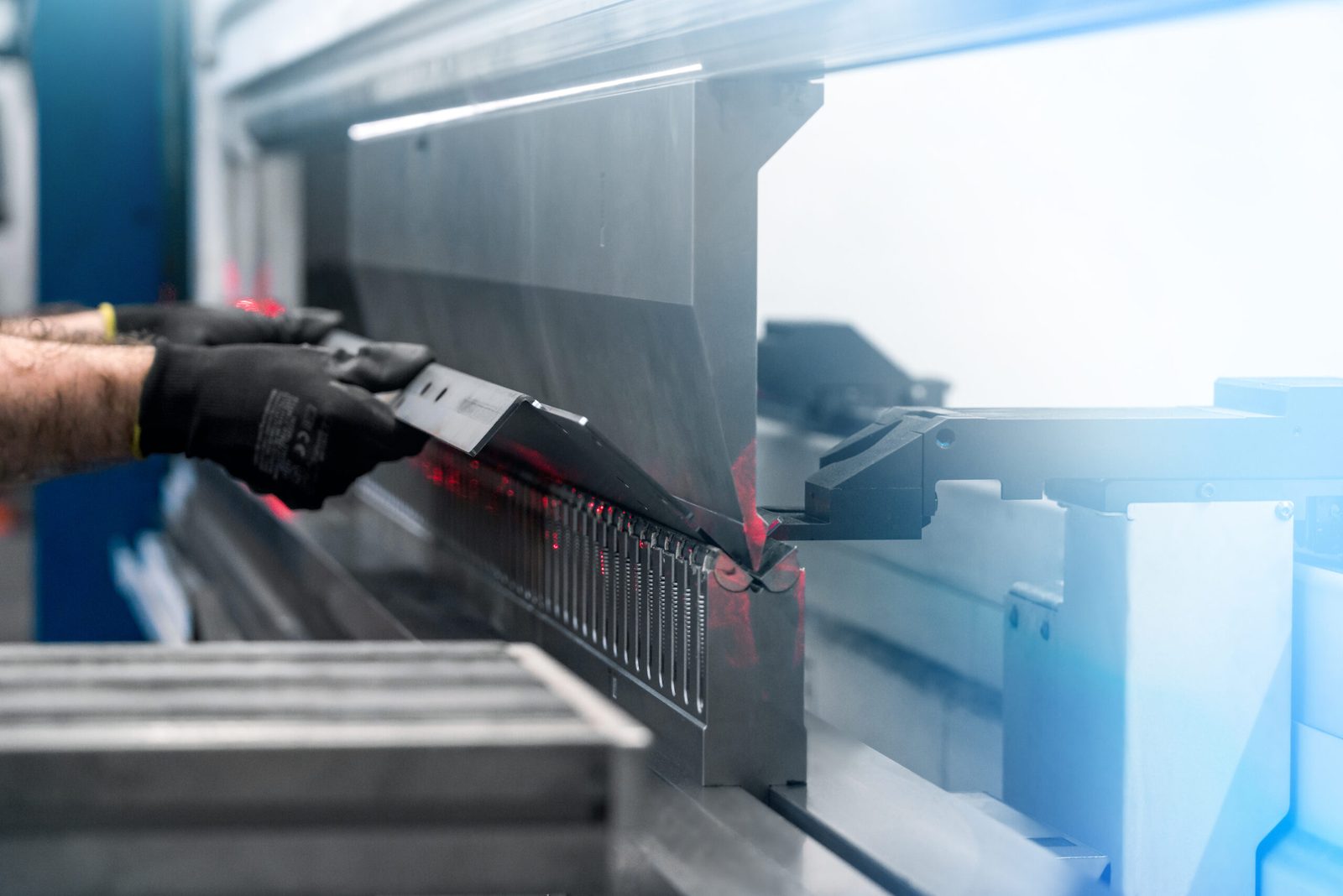 Close-up of a sheet metal part being bent on a CNC press brake
