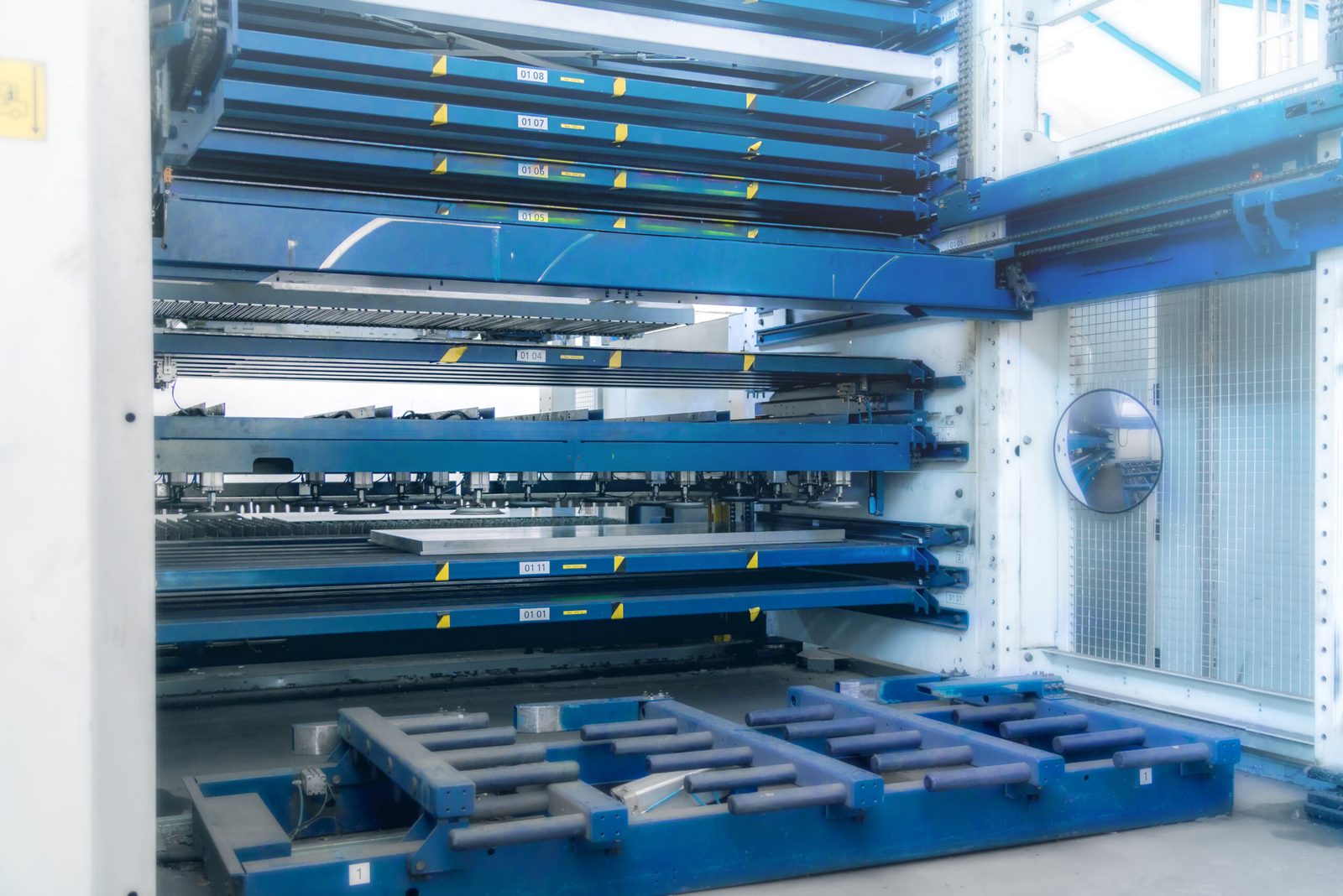 Automated sheet storage tower with drawers and roller feed
